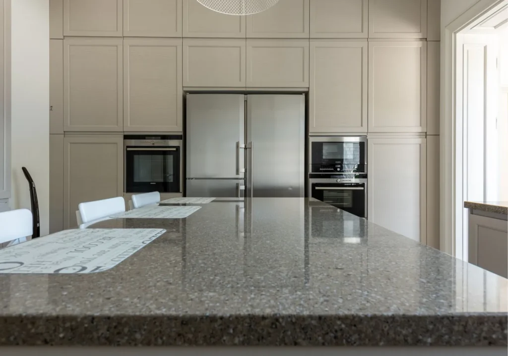 A statement island made with dark stone countertop in a modern kitchen