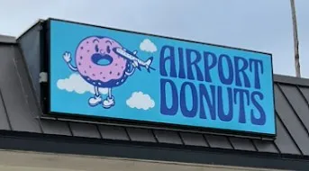 Airport Donuts sign with a flying donut logo
