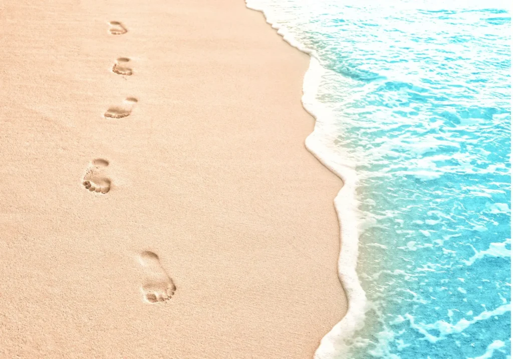 Arial view of Beach shore line with footprints in the sand