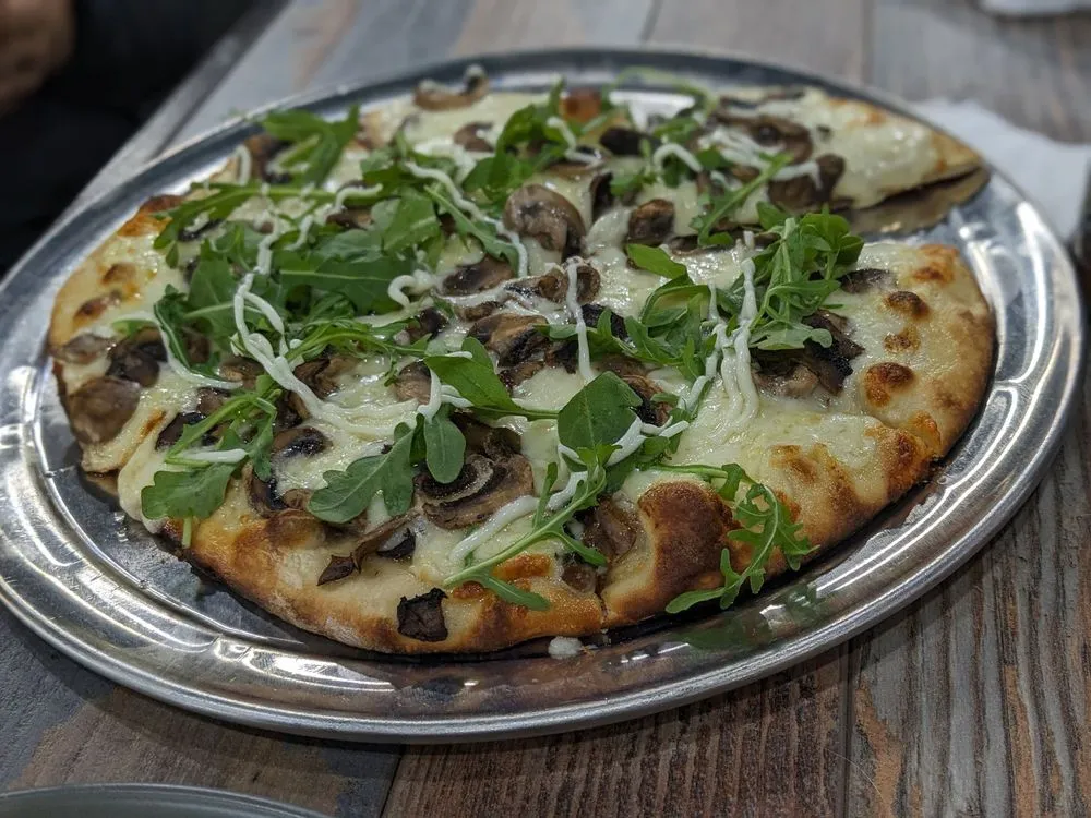 Artisan pizza with fresh greens