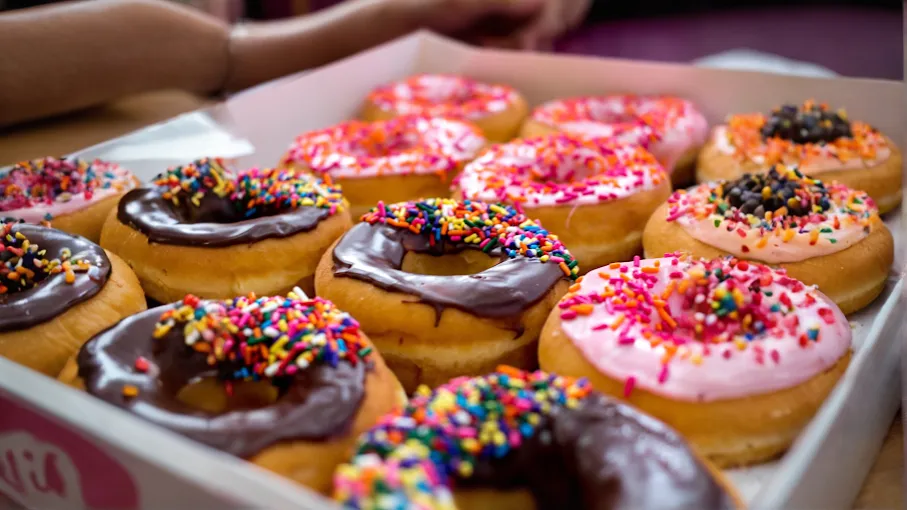 Assorted frosted donuts with sprinkles at Airport Donuts