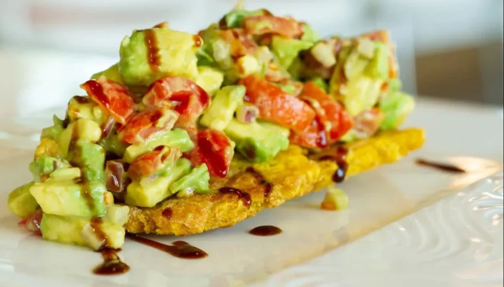 Avocado and tomato topped tostada at Paella's