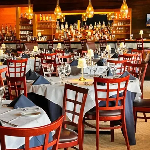Bar and dining room with red chairs at Amber Cove restaurant