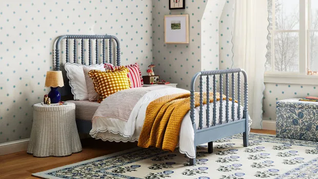 Bedroom with spindle bed and floral wallpaper from Birch Lane