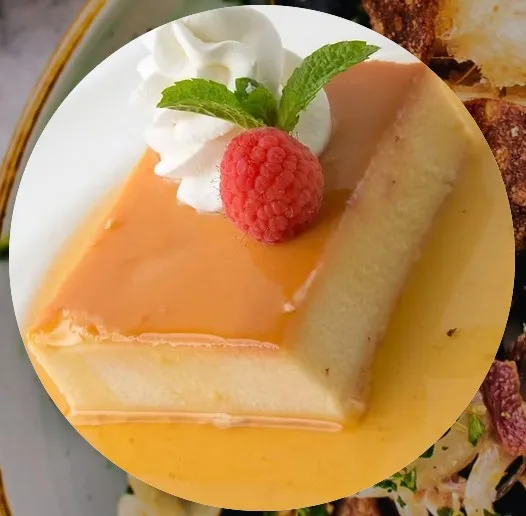 Caramel flan with whipped cream and raspberry at Paella's