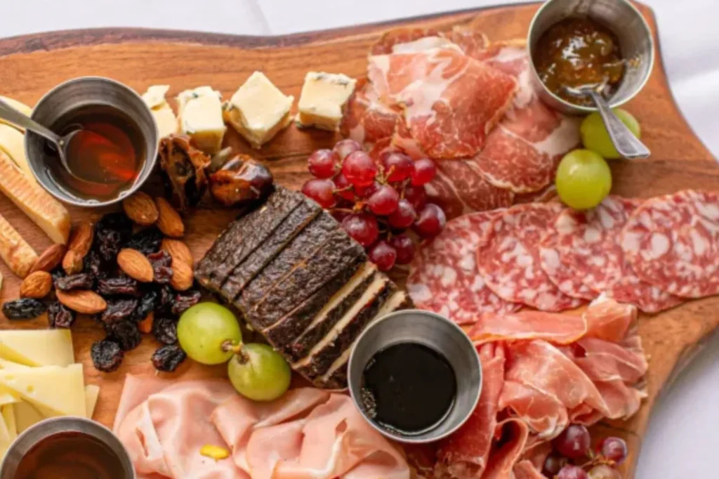 Charcuterie board with cured meats, cheese and grapes at Casa Cotzelli