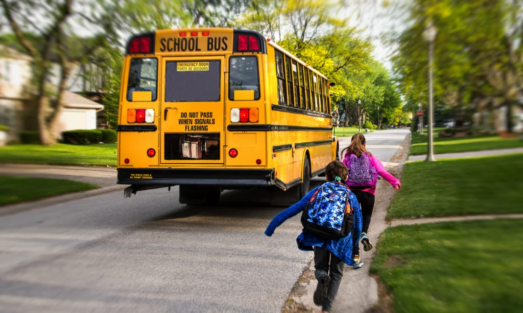 children running for school bus