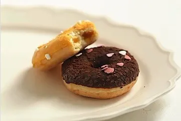 Chocolate and glazed donuts on a plate at Airport Donuts
