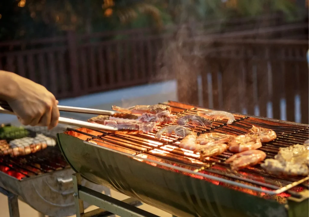 Close up of chicken cooking on an outdoor grill