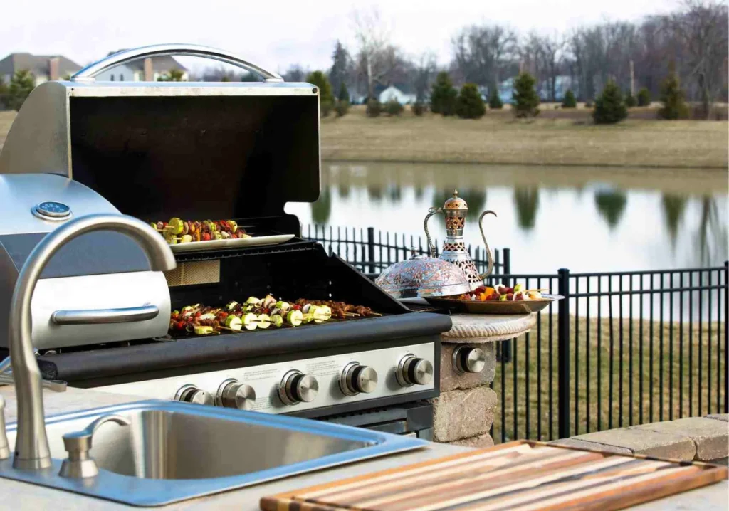 Close up of outdoor grill with lake in background