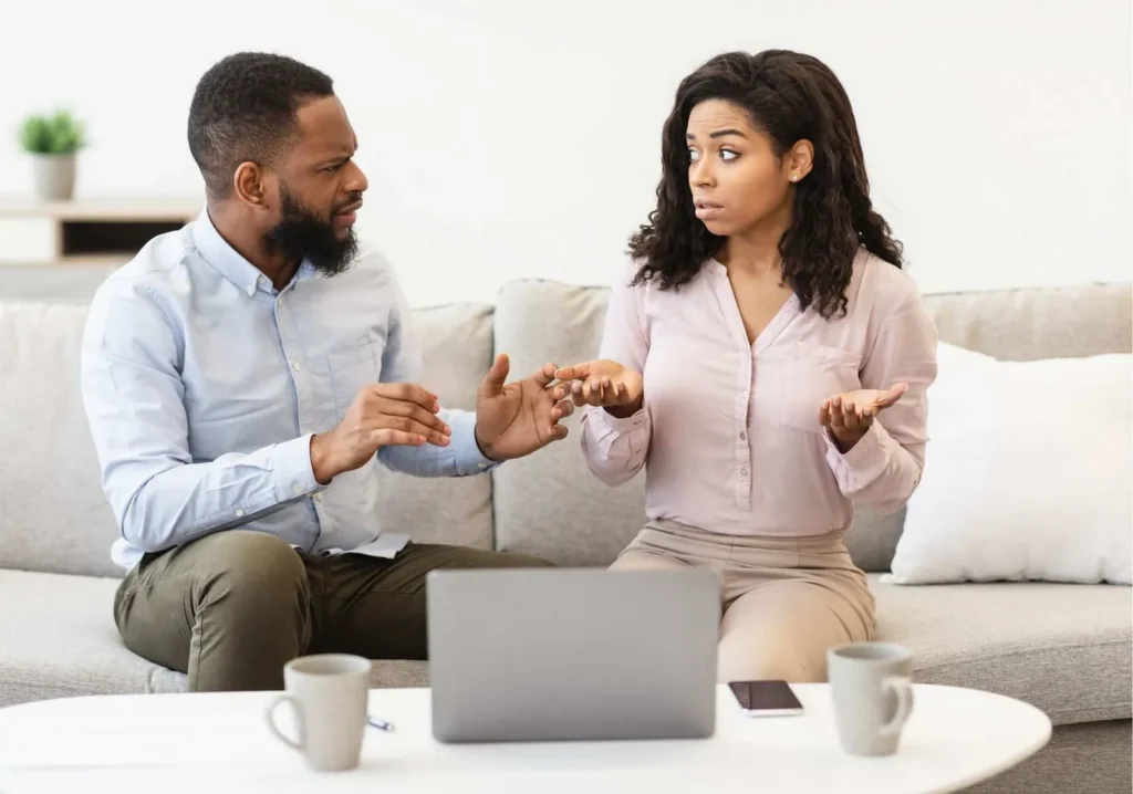 Couple confused while looking at choices on laptop