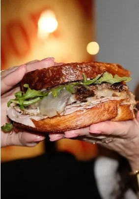 Delicious sandwich being held