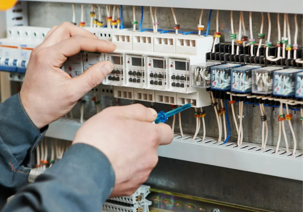 Electrician testing electrical panel