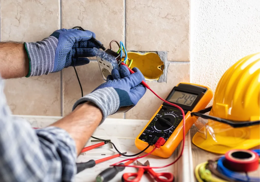 Electrician testing wiring with a multimeter