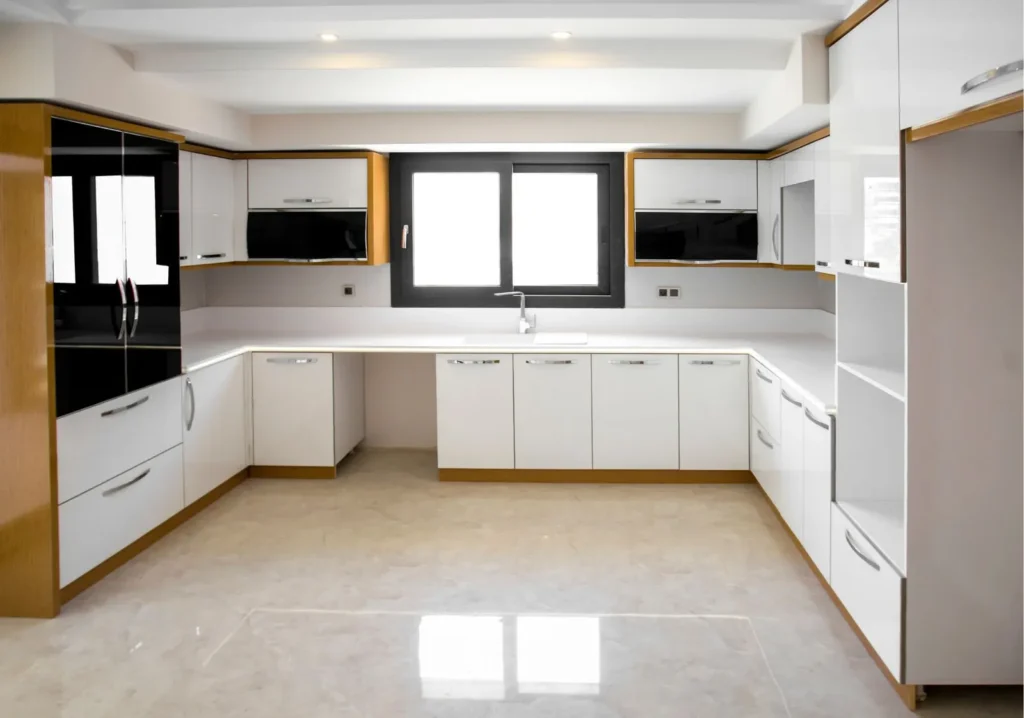 Empty white kitchen in an unfurnished home
