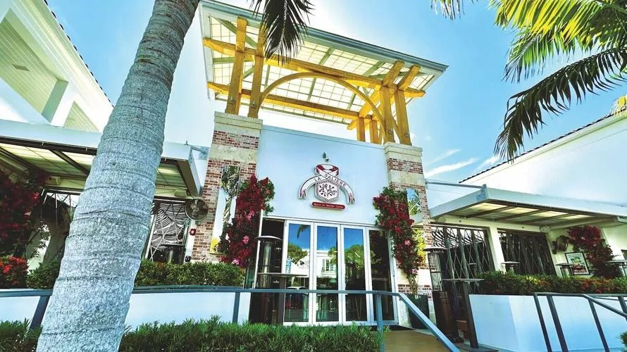 Exterior entrance of La Saliere restaurant with palm trees
