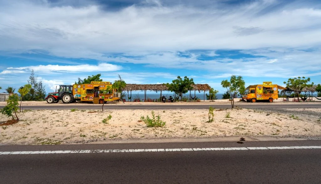 Food trucks parked beside a sunny Florida beach