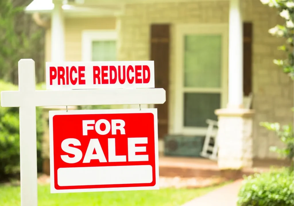 For sale sign showing that price is reduced