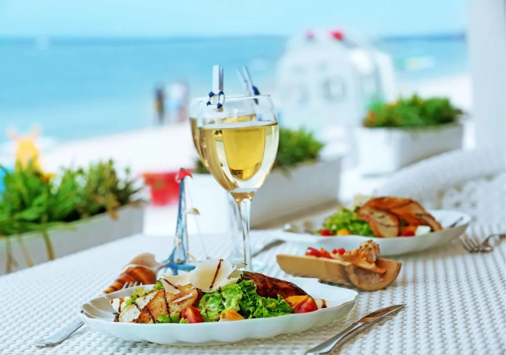 Gourmet meal with wine on the beach