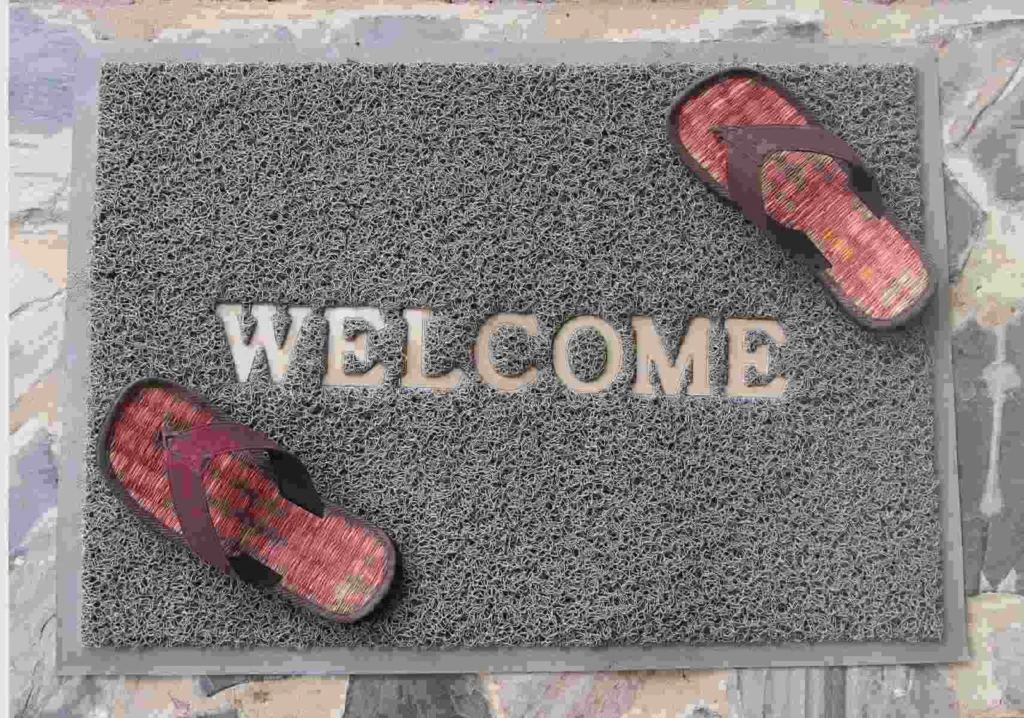 Gray Welcome mat with pair of sandals