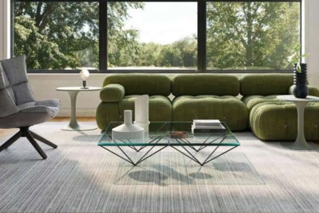 Green modular sofa and glass coffee table by B&B Italia