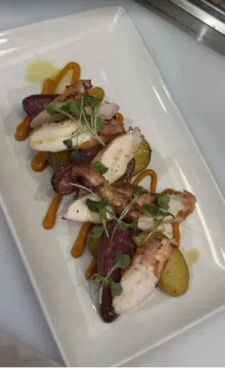 Grilled octopus plated at Paella's