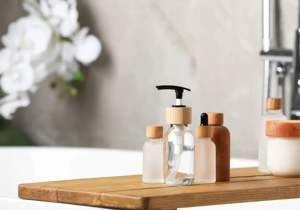 Grouping of bath essentials in small jars on a wooden slab