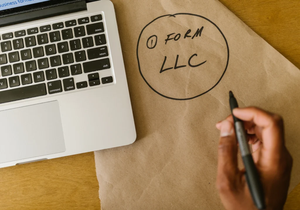 Hand and computer and the words form LLC