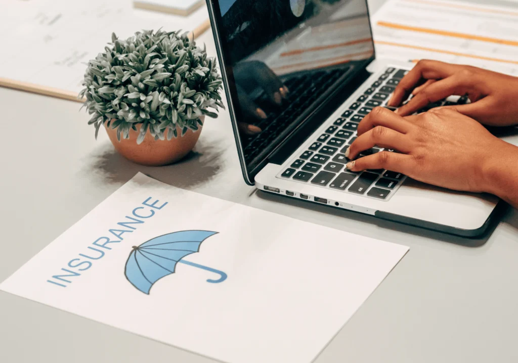 Hands on computer and insurance document
