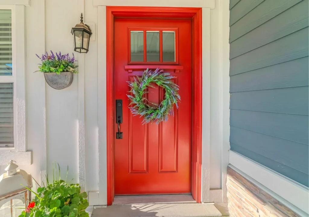 Home red front door with green wreath