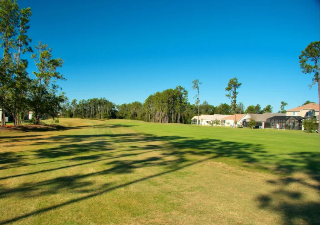 Long grassy view of home in the far background