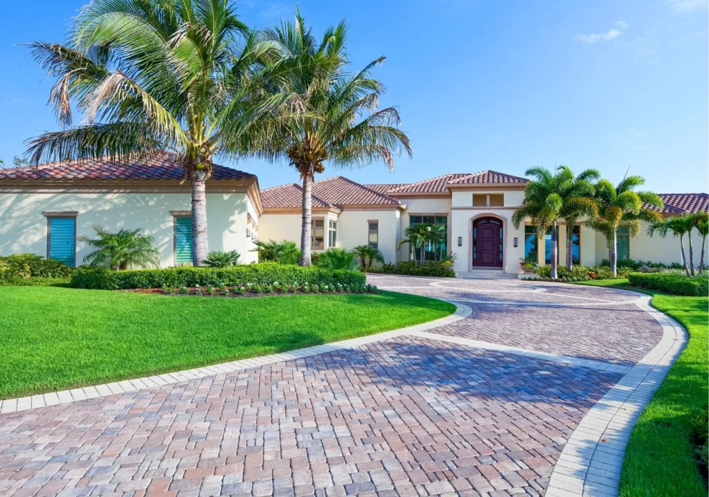 Long view of brick driveway leading to Naples home