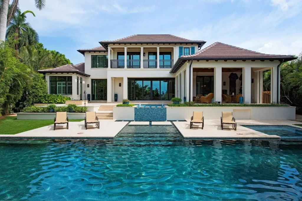 Luxury Naples home with a rectangular pool and lounge chairs