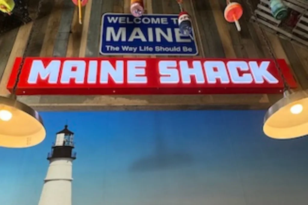 Maine Shack restaurant sign with a lighthouse mural
