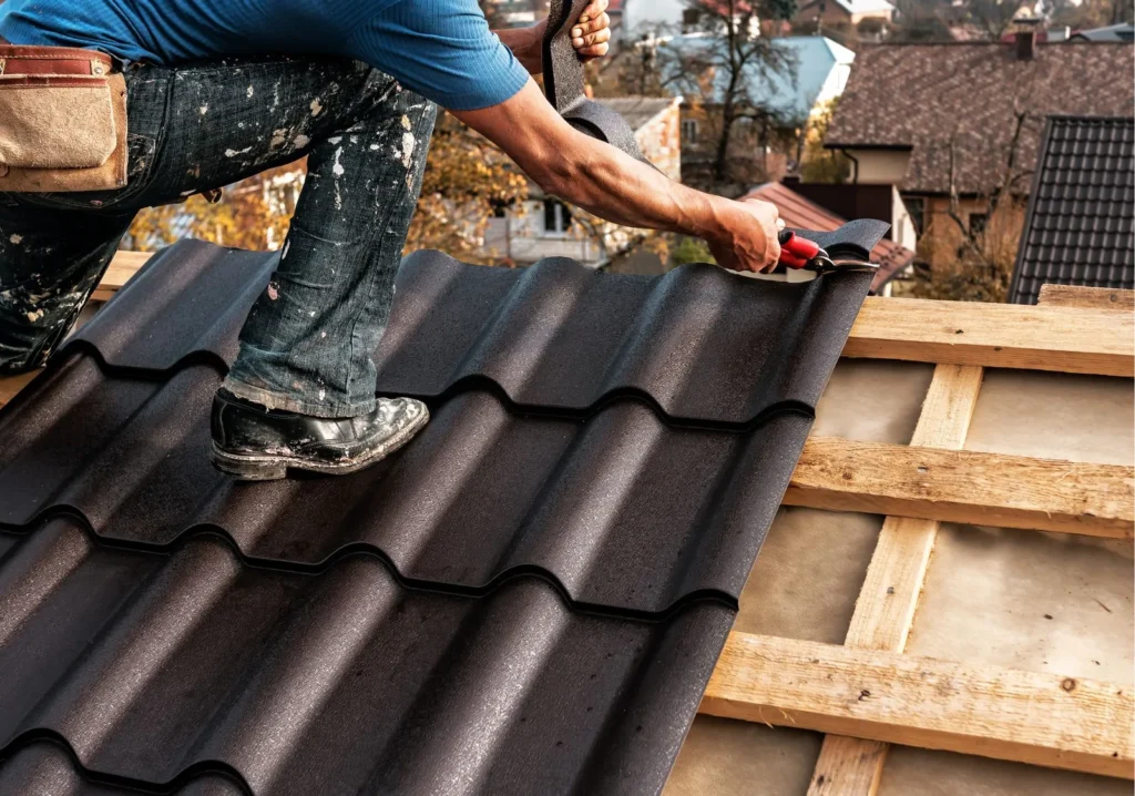 Man placing new tiles on rooftop