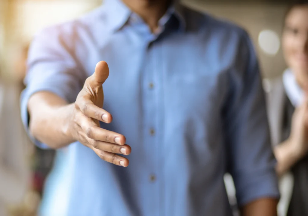 Man reaching out to shake hand