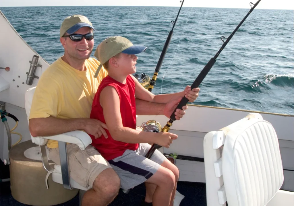 Man with young boy fishing in the gulf