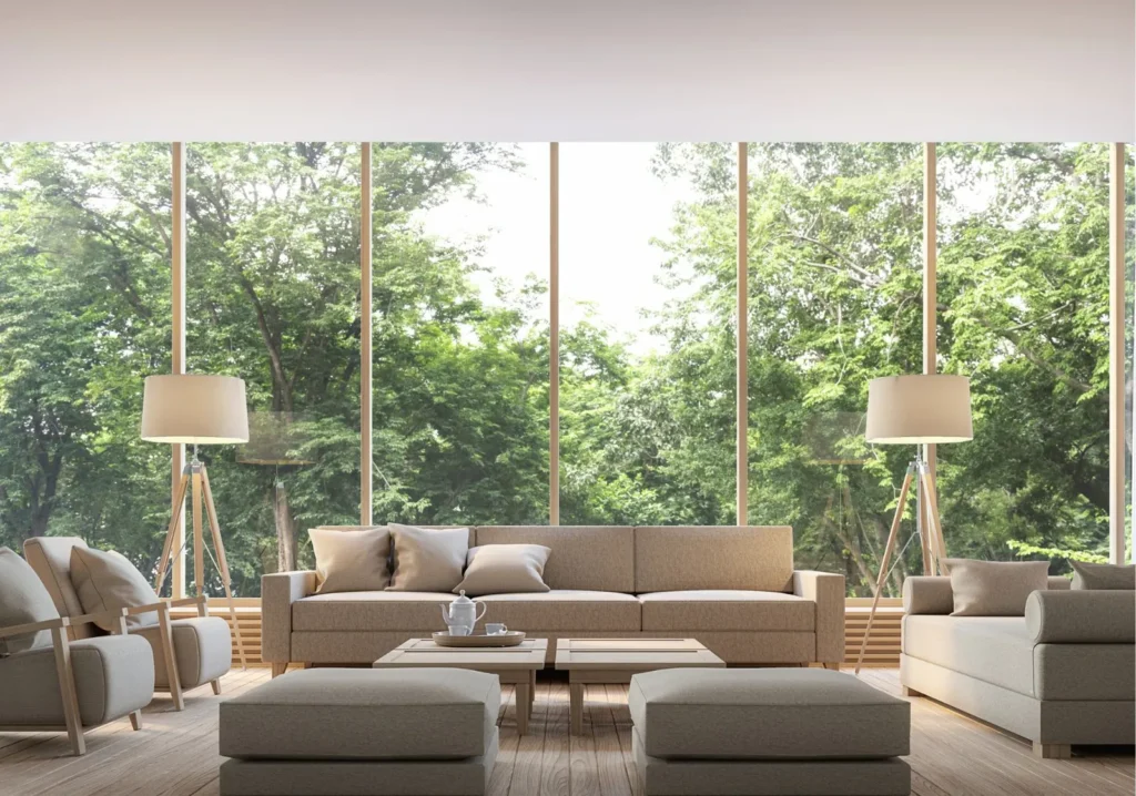 Modern living room in front of glass wall with green foliage