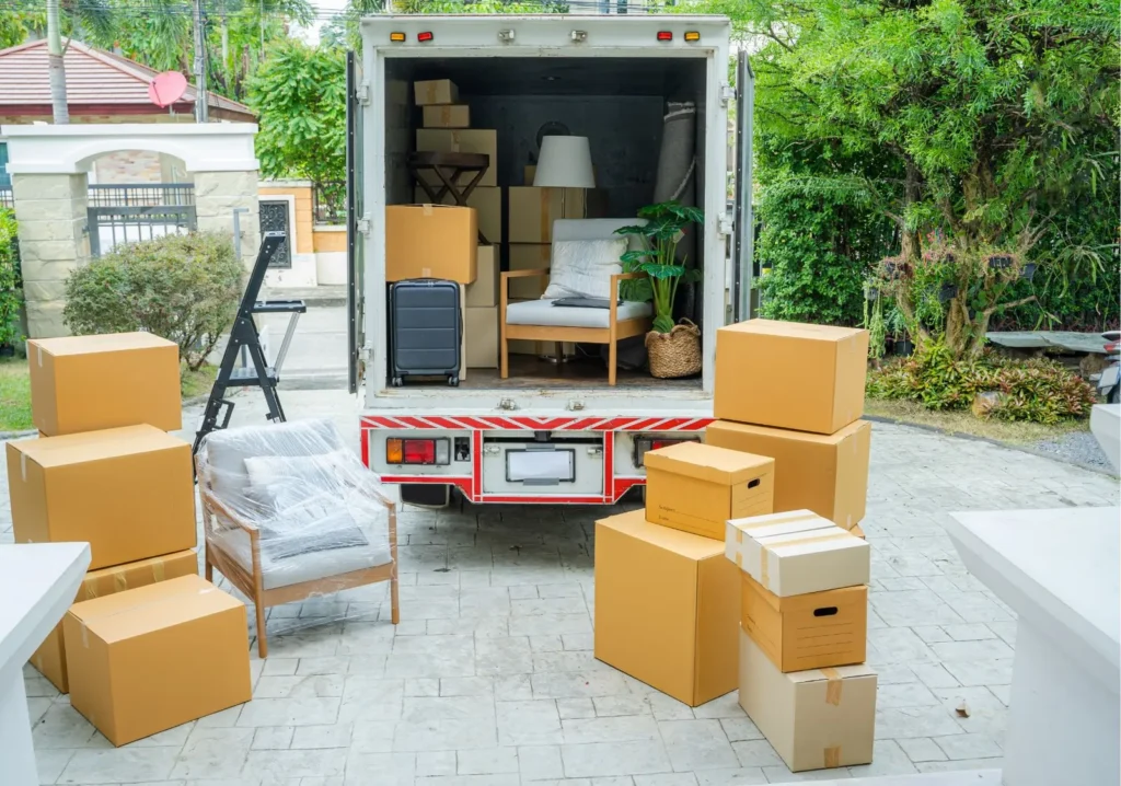 Moving van with piles of brown boxes piled outside the truck