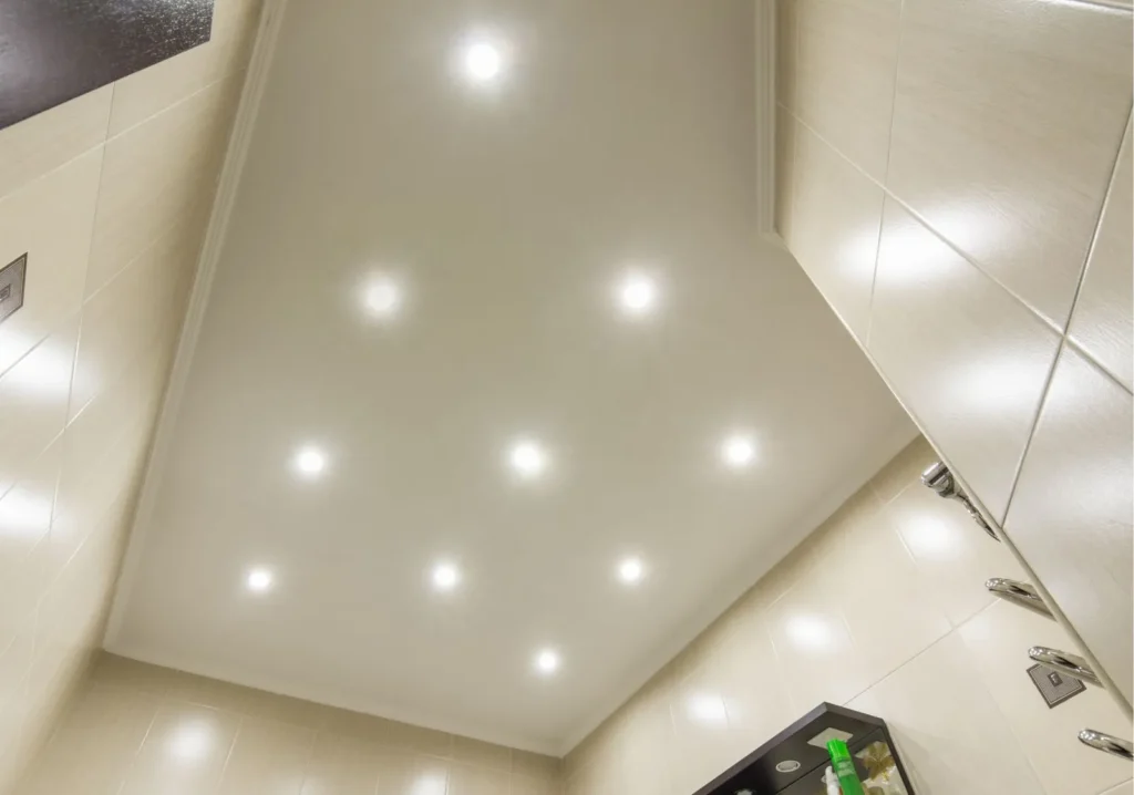 Multiple modern small round white ceiling lights in bathroom