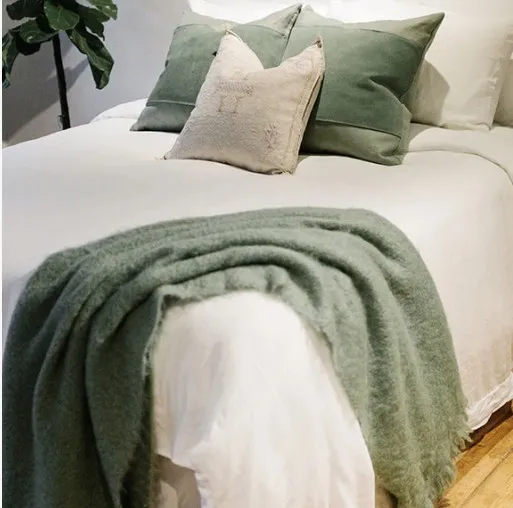 Neutral contemporary bed with green accents