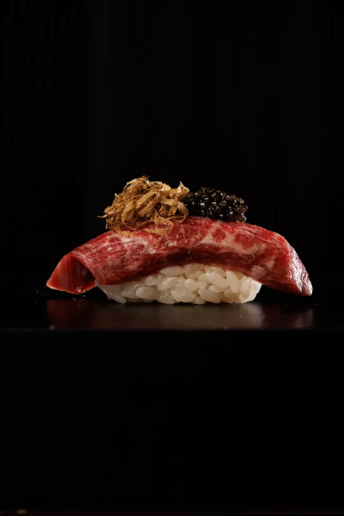 Nigiri sushi topped with crispy garnish at Omasava