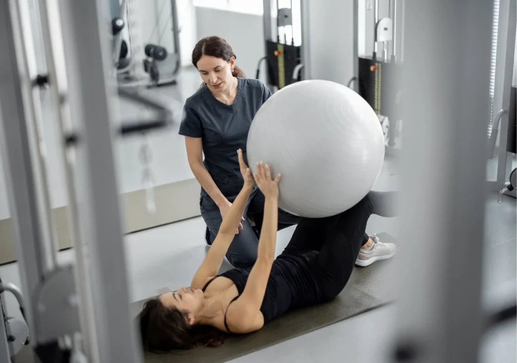 Physical Therapist working with young woman at Hospital for Surgery (HSS).