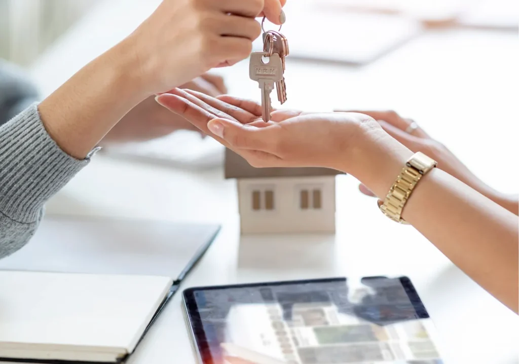 Real Estate Agent handing keys to new homeowner