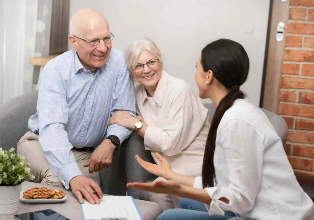 Real Estate Agent with happy senior couple