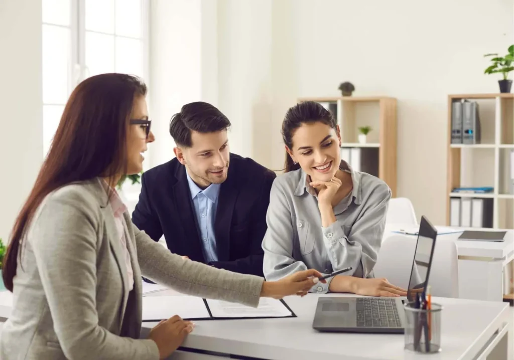 Real Estate Agent working with young couple reviewing options