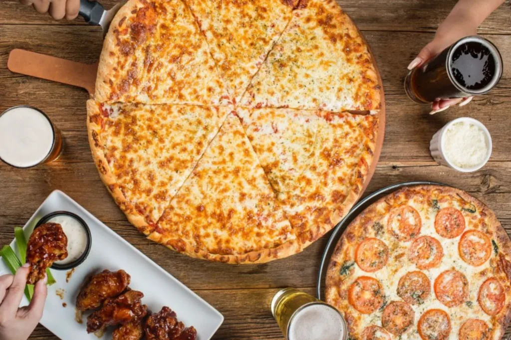 Rosati's pizzas, wings and drinks on a table