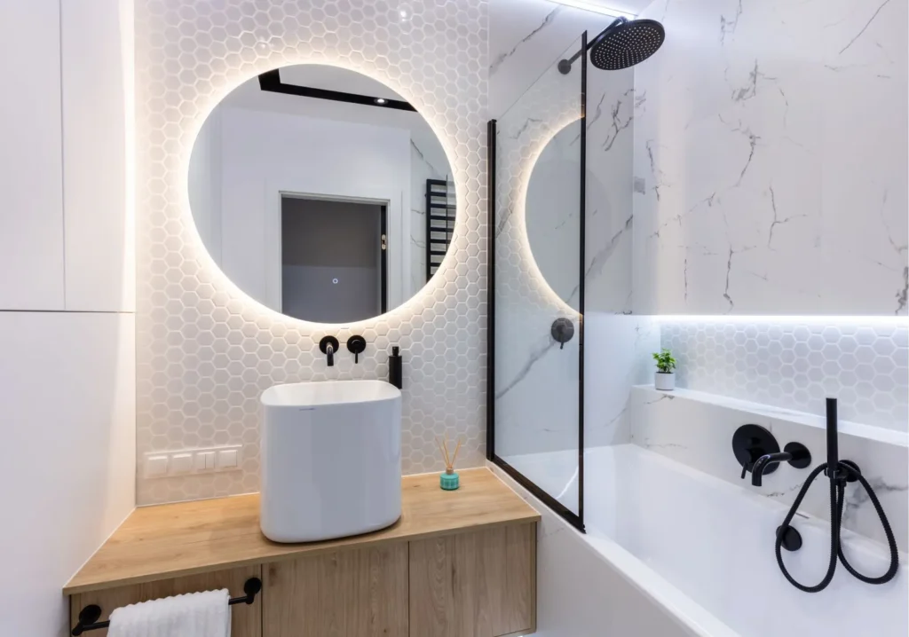 Round vanity mirror with backlighting in bathroom