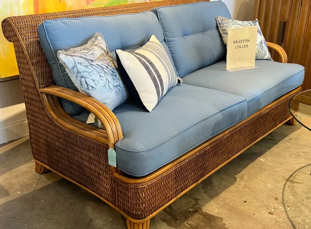 Second hand outdoor sofa with blue cushions