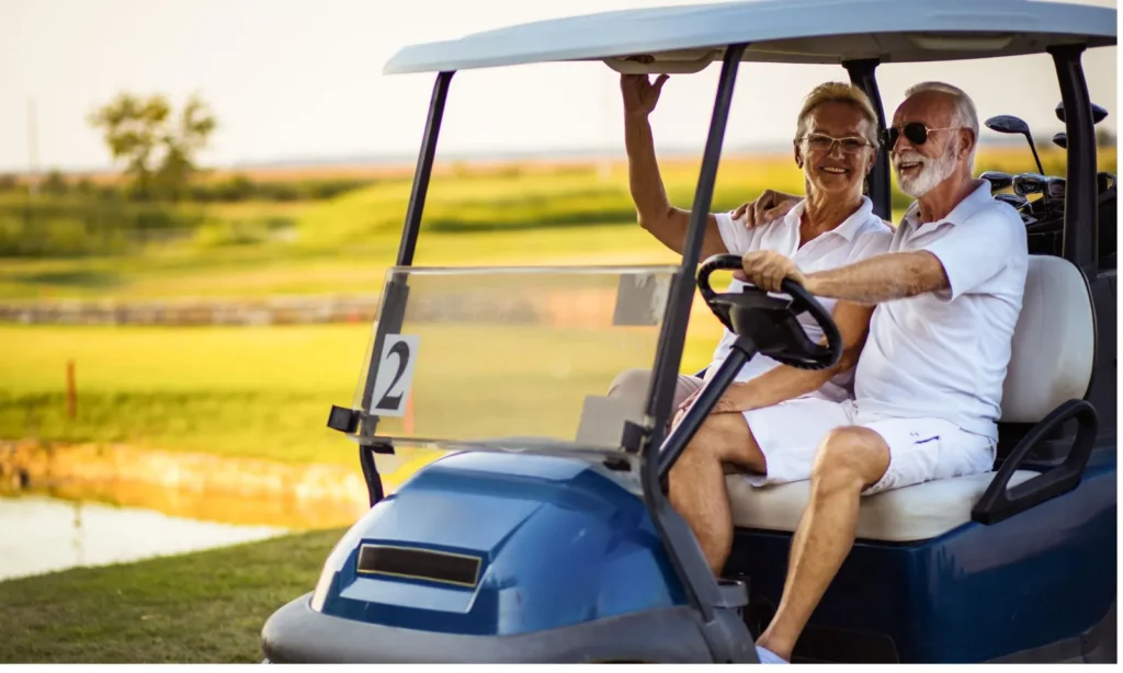 seniors in a golf cart